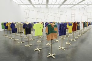 Jonathas de Andrade, Suar a Camisa [Working up a Sweat], 2014. Collection of 120 shirts negotiated with workers, wooden supports, variable dimensions. Exhibition view, “Museu do Homen do Nordeste” 2014-2015, Art Museum of Rio (Brazil). Photo Eduardo Ortega, courtesy of the artist & Vermelho gallery (São Paulo)